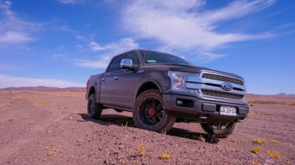 A truck parked in the middle of a desert