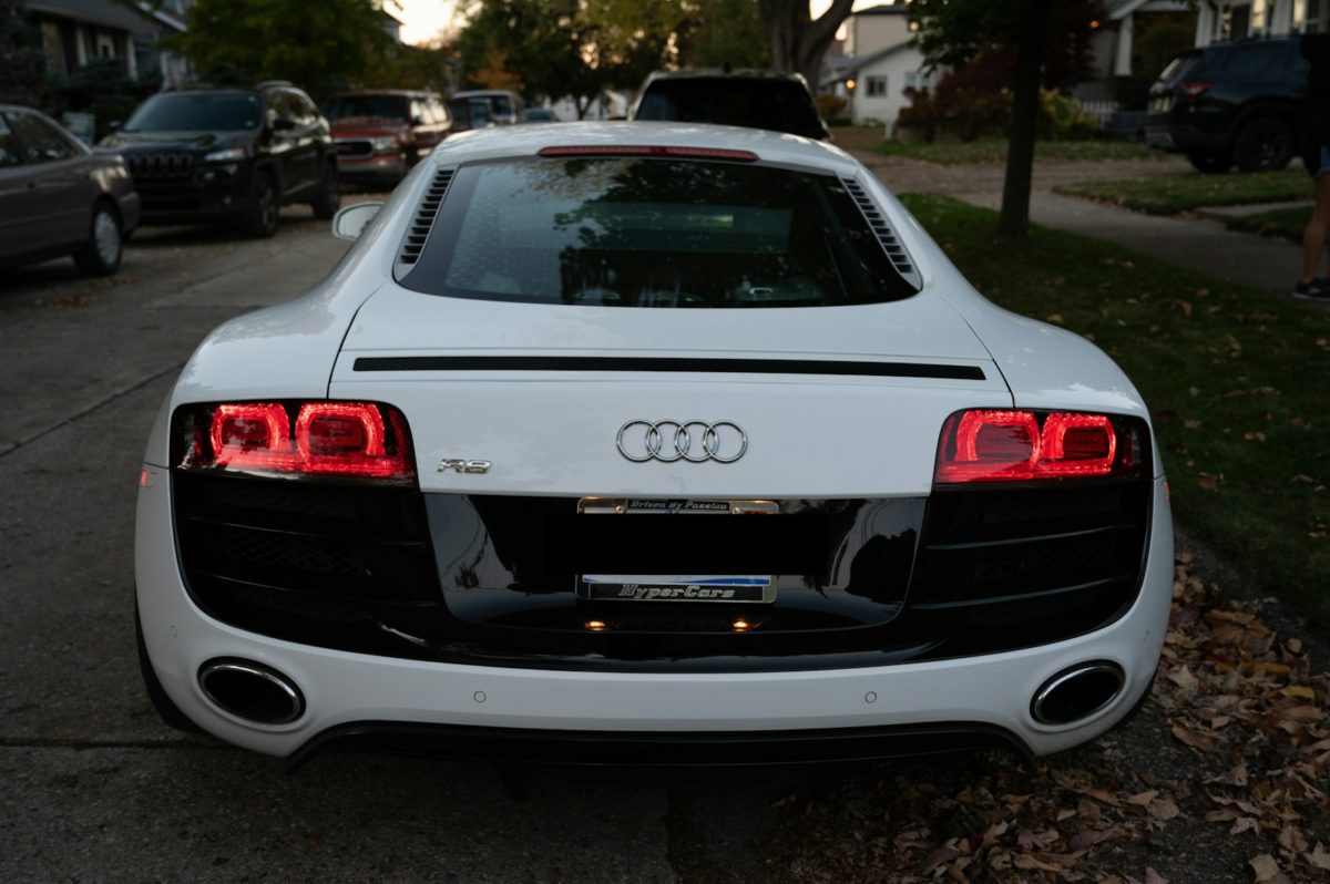 White audi r8 parked on a residential street.
